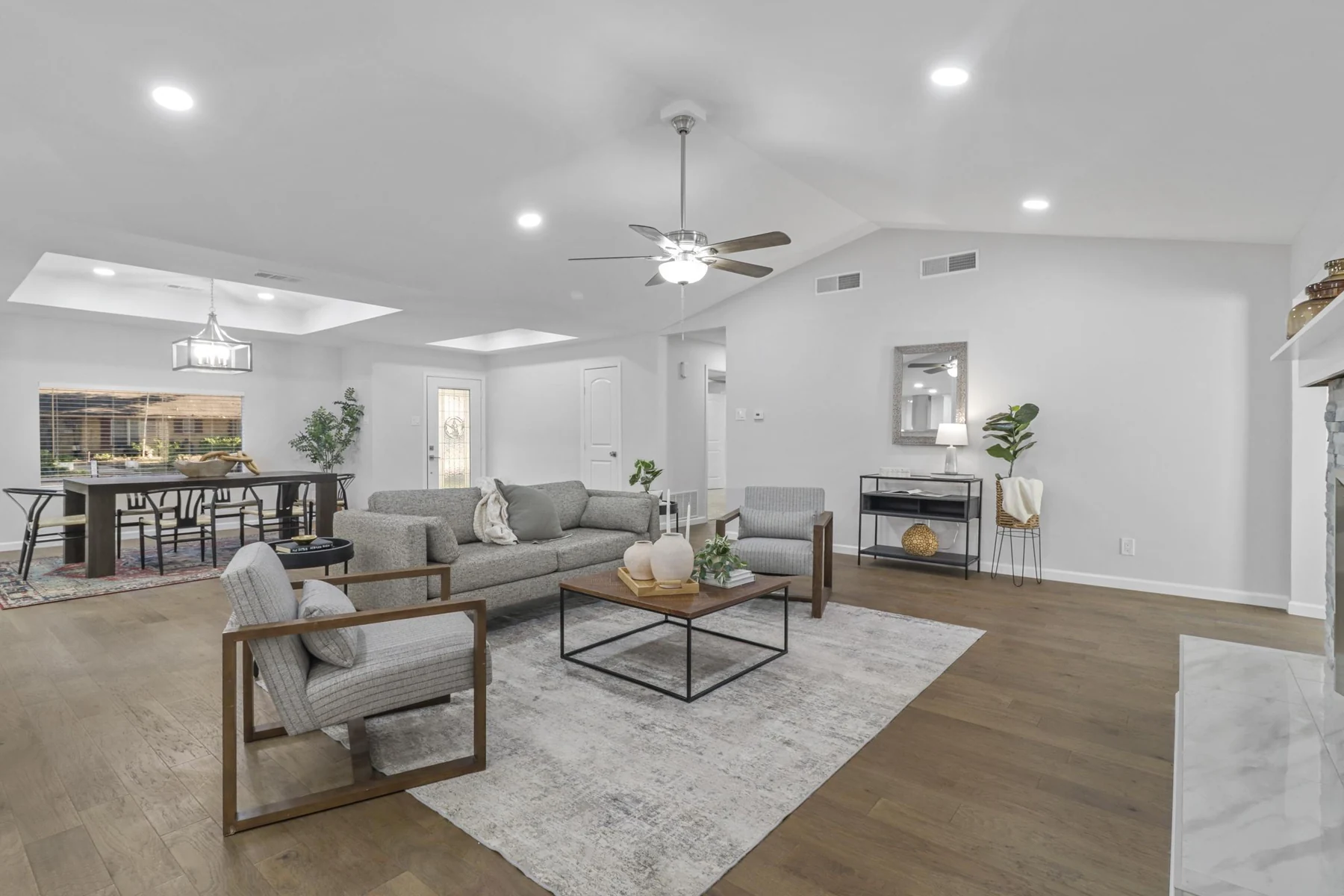 Bright, open living and dining room with a sitting area